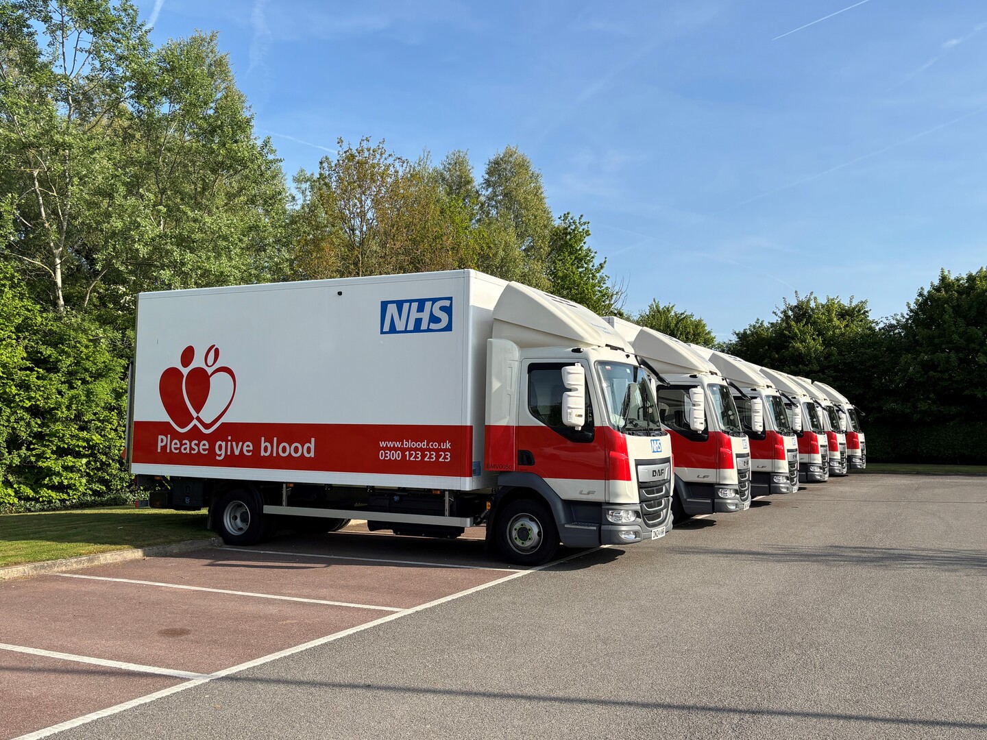 NHS blood donation trucks parked in a row.