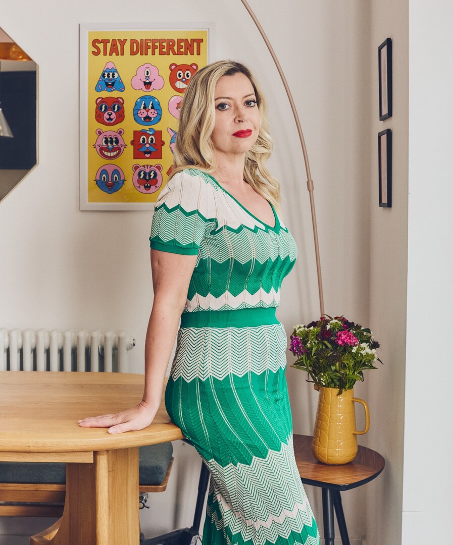 Portrait of Nichy Hodgson in a green and white dress.